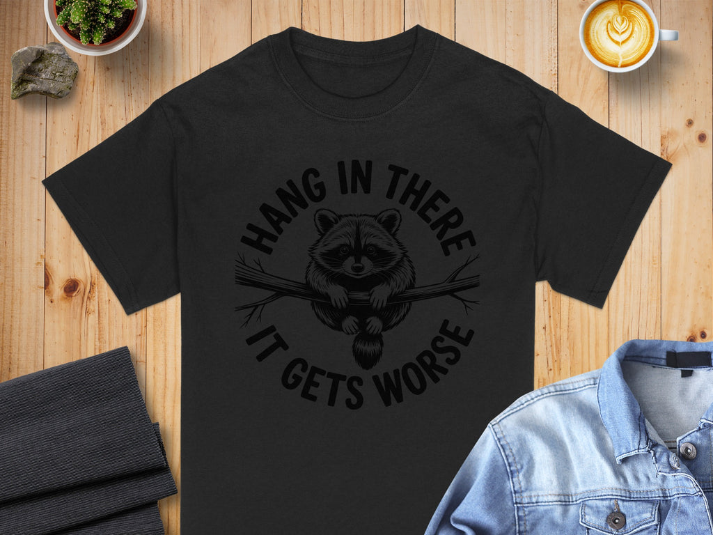 Black t-shirt with raccoon graphic and text "Hang in there it gets worse."