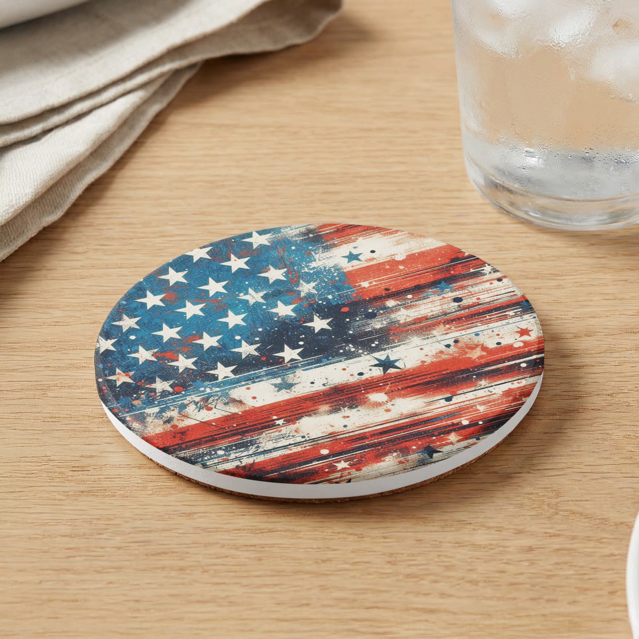 Circular coaster with distressed American flag design on wooden table.